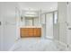Bathroom with double sink vanity, framed mirror, and glass door shower at 33417 Pennbrooke Pkwy, Leesburg, FL 34748
