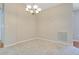 Carpeted dining room with a chandelier, neutral walls, and an air vent at 33417 Pennbrooke Pkwy, Leesburg, FL 34748
