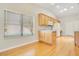 Bright kitchen featuring wood cabinets, stainless steel sink and wood floors with window view at 33417 Pennbrooke Pkwy, Leesburg, FL 34748