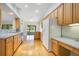 Open kitchen with light wood cabinets, an eat-in area, and a sliding glass door to the sunroom at 33417 Pennbrooke Pkwy, Leesburg, FL 34748