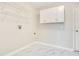Laundry room features storage cabinets, wire shelves, and tile flooring at 33417 Pennbrooke Pkwy, Leesburg, FL 34748