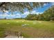 Lawn bowling area with seating benches and grass, and a clear blue sky in a lovely community at 33417 Pennbrooke Pkwy, Leesburg, FL 34748