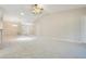 Bright, airy living room boasting neutral carpet and paint and a view of the entry at 33417 Pennbrooke Pkwy, Leesburg, FL 34748
