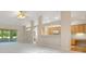 Open-concept living area offers neutral color palette, ceiling fan, and sunroom access at 33417 Pennbrooke Pkwy, Leesburg, FL 34748