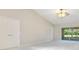 Bright main bedroom features neutral carpet and paint, ceiling fan and a view of the sunroom at 33417 Pennbrooke Pkwy, Leesburg, FL 34748