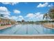 A full shot of the community pool with multiple swim lanes, poolside seating, and clear blue skies at 33417 Pennbrooke Pkwy, Leesburg, FL 34748