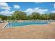 A full shot of a community pool, lounge chairs and tables, and umbrellas for a day of fun in the sun at 33417 Pennbrooke Pkwy, Leesburg, FL 34748