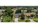 An aerial view of a single-story home with a lush green lawn and a backdrop of mature trees and neighborhood homes at 3677 Park Green Ct, Tavares, FL 32778