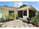 Back patio with tile flooring, screened in area and a beautiful array of plants at 3677 Park Green Ct, Tavares, FL 32778