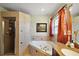 Bright bathroom with tub, shower, window, vanity, and stylish decor at 3677 Park Green Ct, Tavares, FL 32778