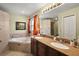 Spacious bathroom with double vanity, soaking tub, and separate shower stall at 3677 Park Green Ct, Tavares, FL 32778
