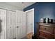 Bedroom featuring closet doors, dresser, and contrasting wall color at 3677 Park Green Ct, Tavares, FL 32778
