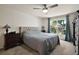 Comfortable bedroom features a ceiling fan and window view with natural light at 3677 Park Green Ct, Tavares, FL 32778
