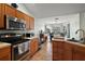 Kitchen space with stainless steel appliances and a view of the adjacent dining area at 3677 Park Green Ct, Tavares, FL 32778
