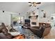 Inviting living area featuring a fireplace, comfortable seating, and a sliding glass door at 3677 Park Green Ct, Tavares, FL 32778