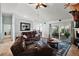Comfortable living room with leather seating, a coffee table, and sliding glass doors at 3677 Park Green Ct, Tavares, FL 32778