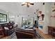 Spacious living room with leather sofas, a fireplace, and access to the outdoors at 3677 Park Green Ct, Tavares, FL 32778