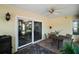 Covered patio with tile flooring, ceiling fan, and sliding glass doors to the home's interior at 3677 Park Green Ct, Tavares, FL 32778