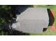 A bird's eye view of the roof and surrounding lawn shows mature trees and shrubbery at 3718 Westerham Dr, Clermont, FL 34711