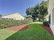 Well-manicured backyard with lush greenery and mature trees provides a private outdoor space at 3718 Westerham Dr, Clermont, FL 34711