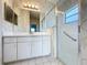 Bathroom with vanity, mirror, and glass enclosed shower with grab bar at 3718 Westerham Dr, Clermont, FL 34711