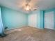 Bright bedroom featuring blue walls, ceiling fan, closet and door at 3718 Westerham Dr, Clermont, FL 34711