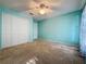 This is a light and airy bedroom with white closet doors and a ceiling fan at 3718 Westerham Dr, Clermont, FL 34711