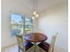 Cozy breakfast nook features a round wooden table and large window with natural light at 3718 Westerham Dr, Clermont, FL 34711