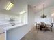 Open kitchen and dining area with white cabinets and a chandelier at 3718 Westerham Dr, Clermont, FL 34711
