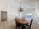 The dining room features an elegant chandelier and lots of natural light at 3718 Westerham Dr, Clermont, FL 34711