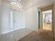 A bright foyer, featuring tile and carpet flooring, provides entry to the home at 3718 Westerham Dr, Clermont, FL 34711
