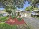 Charming single-story home with well-maintained lawn, landscape beds, and attached two-car garage at 3718 Westerham Dr, Clermont, FL 34711