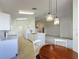 Bright kitchen and dining area with white cabinets and views into the living spaces at 3718 Westerham Dr, Clermont, FL 34711