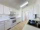 A well-lit kitchen boasts bright cabinets, modern appliances, and tile flooring at 3718 Westerham Dr, Clermont, FL 34711