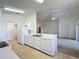 Bright open-concept kitchen featuring bright cabinets and modern appliances with an open view of the living room at 3718 Westerham Dr, Clermont, FL 34711