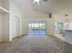 Expansive living area with sliding glass doors, dining space and views into kitchen at 3718 Westerham Dr, Clermont, FL 34711
