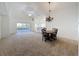 Open-concept living area featuring sliding glass doors and adjacent dining space at 3718 Westerham Dr, Clermont, FL 34711