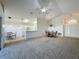 Open living space with white kitchen, dining area, and entrance view under vaulted ceilings at 3718 Westerham Dr, Clermont, FL 34711