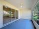 Screened lanai featuring sliding glass doors and ceiling fan, connecting the indoor space to the outdoors at 3718 Westerham Dr, Clermont, FL 34711