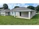 Backyard with covered patio on a sunny day at 435 Woodview Dr, Tavares, FL 32778