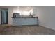 Bright kitchen featuring white cabinets and modern wood flooring at 435 Woodview Dr, Tavares, FL 32778