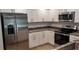 Modern kitchen featuring stainless appliances and granite counters at 435 Woodview Dr, Tavares, FL 32778