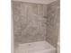 New tiled shower-tub combo with built in shelf at 435 Woodview Dr, Tavares, FL 32778