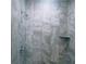 This shower features beautiful marble-look tiling at 435 Woodview Dr, Tavares, FL 32778