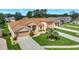 Aerial view of a well-maintained property featuring a lush lawn and a spacious driveway at 4716 Heritage Trl, Leesburg, FL 34748