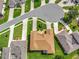 An aerial view of a well-manicured property in a tranquil neighborhood with lush green lawns and beautiful landscaping at 4716 Heritage Trl, Leesburg, FL 34748