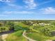 A winding golf course and rows of homes stretch into the horizon in this aerial view at 4716 Heritage Trl, Leesburg, FL 34748