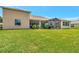 Spacious backyard featuring lush green grass and a screened-in patio at 4716 Heritage Trl, Leesburg, FL 34748