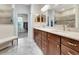 Spacious bathroom with double sinks, granite countertop, and a seamless glass shower at 4716 Heritage Trl, Leesburg, FL 34748