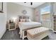 Relaxing bedroom with a decorative headboard, carpet flooring, and natural light from the window at 4716 Heritage Trl, Leesburg, FL 34748